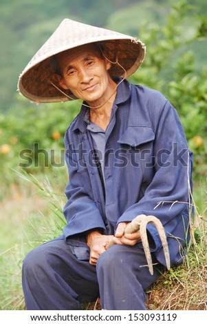 asian chinese farm man worker with shovel in china agriculture field