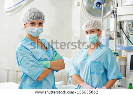 Team of surgery nurses in uniform before operation at cardiac surgery clinic