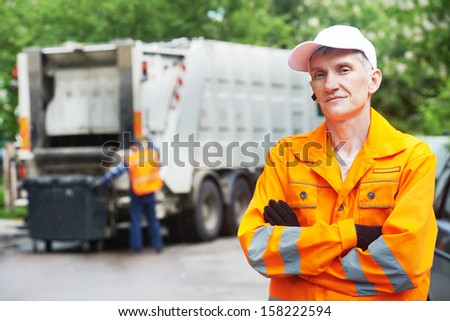 Portrait Of Municipal Worker Recycling Garbage Collector Truck Loading Waste And Trash Bin