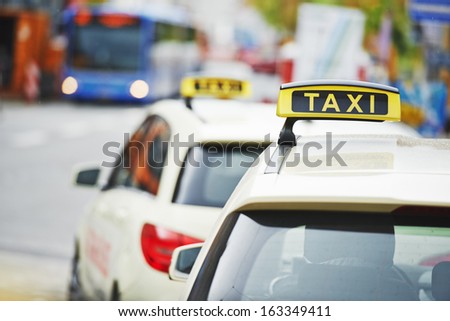 yellow taxi cab cars waiting  for a client passenger in turn