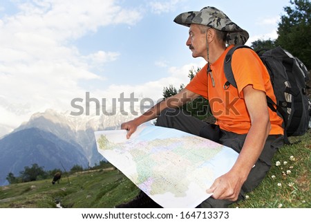 tourist traveller hiker with route map in Himalayas mountains