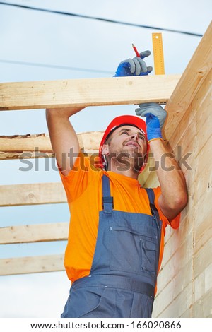 construction carpenter worker measuring wood board with angle on roof installation work