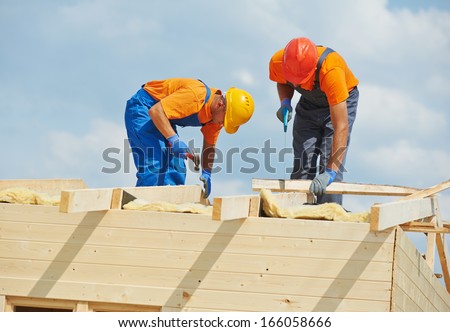 Two Construction Carpenters Roofers Workers Installing Wood Board Roof