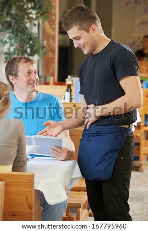waiter ready to serving or order in small italian restaurant