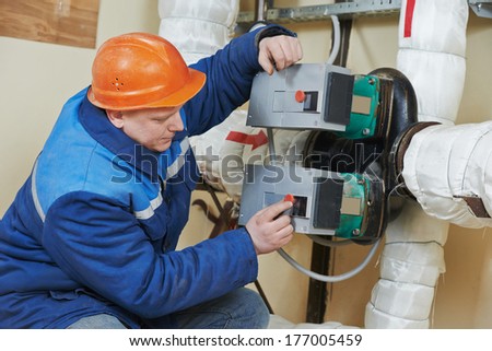 repairman engineer of fire engineering system or heating system open the valve equipment in a boiler house