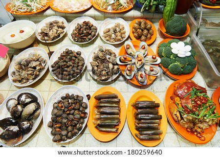 Hong Kong Street seafood. shells, snails, oysters, shrimp, crab at night market.