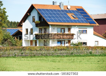 Alternative energy. Solar panels on modern house cottage roof
