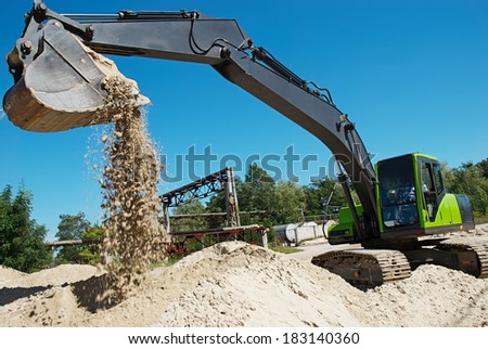 excavator machine at excavation work in sand quarry