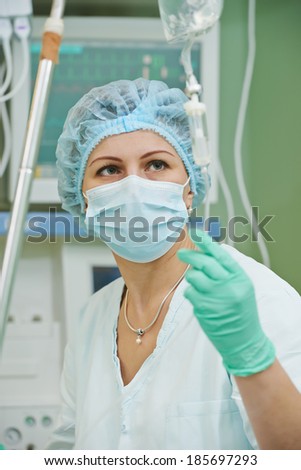 anaesthesiologist doctor in uniform preparing narcosis anaesthesia during heart transplantation operation at cardiac surgery clinic