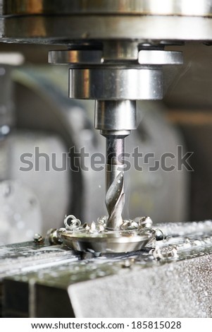 Close up machining tool drill during metal cutting process boring a hole