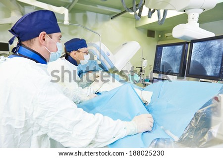 Team of vascular surgeon in uniform perform operation on a patient at cardiac surgery clinic