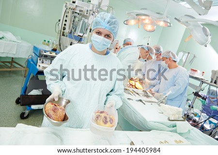 Team of surgeon perform heart transplantation operation on a patient at cardiac surgery clinic