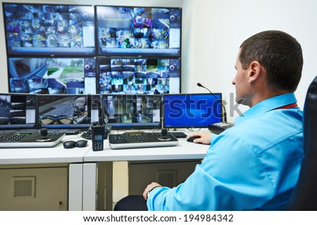security guard watching video monitoring surveillance security system