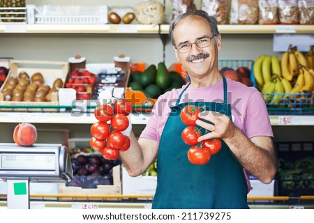 adult senior sale man with tomato at vegetable market shopping store