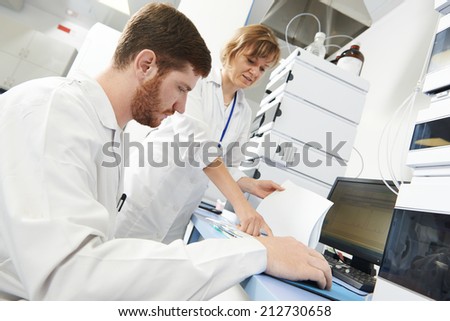 researchers team work at computer scientific analysing data out scientific test in chemistry laboratory