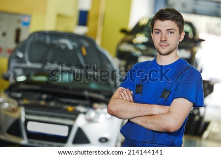 repairman auto mechanic portrait in car auto repair or maintenance shop service station