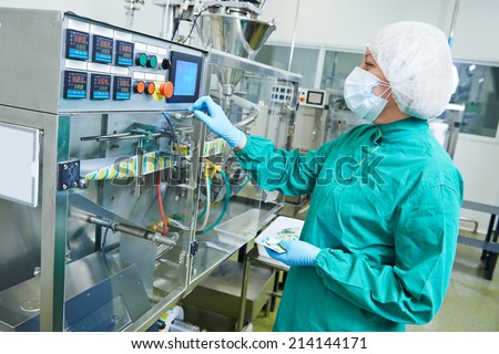 pharmaceutical factory woman worker operating production line at pharmacy industry manufacture factory
