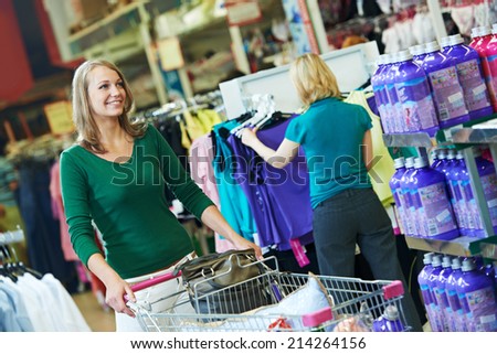 woman with shopping cart trolley in apparel clothes shop supermarket