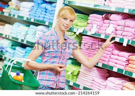 woman choosing bath towels textile in apparel clothes shop supermarket