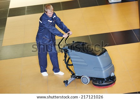 Floor care and cleaning services with washing machine in business centre hall