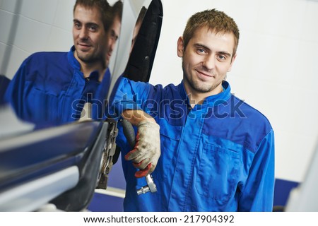 auto repairman mechanic portrait in car auto repair or maintenance shop service station
