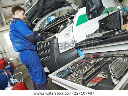 auto repairman industry mechanic worker servicing car auto in repair or maintenance shop service station