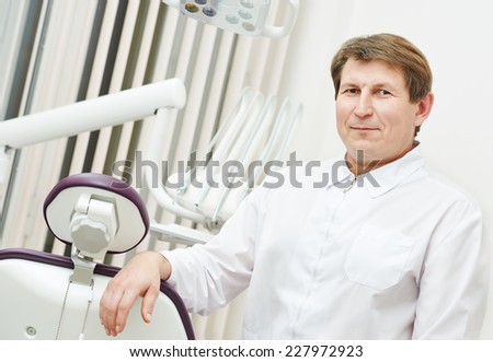 confident dentist orthodontist male doctor portrait at working place