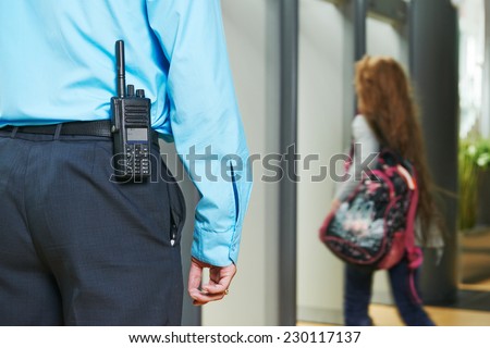 security guard controlling indoor entrance gate