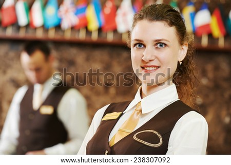 Happy female manager worker standing at hotel