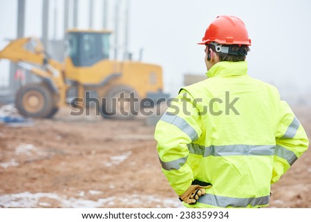 construction foreman worker is watching building works on site