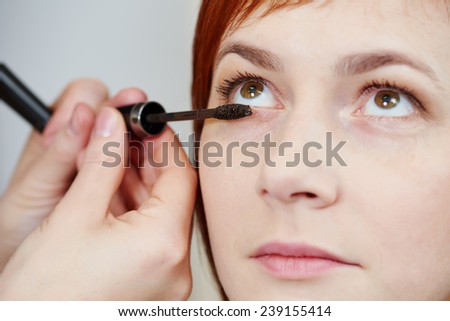 Makeup technique. mascara eyelashes of redheaded woman ?? beauty salon