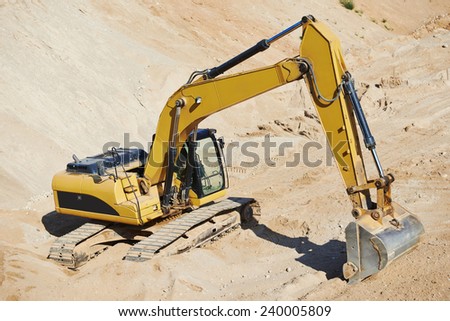 excavator machine at excavation earthmoving work in sand quarry