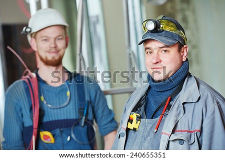 line electrician builder engineer worker at indoor construction site