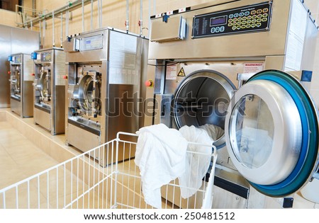 line of industrial laundry machine in laundrette