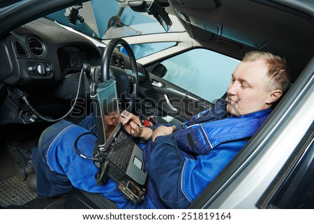 automobile computer diagnosis auto repairman industry mechanic worker servicing car auto in repair or maintenance shop service station