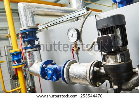 Closeup of manometer, pipes and faucet valves of gas heating system in a boiler room