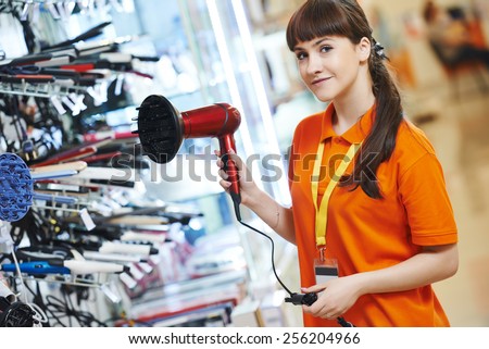 Positive shop assistant in home electric appliance supermarket store