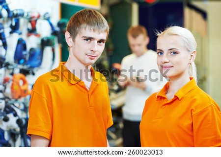 Positive team of sellers or shop assistant group portrait  in supermarket store