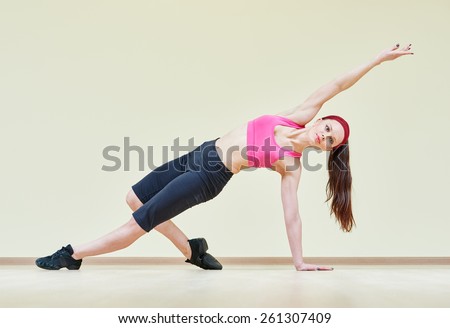 fitness, sport, training, gym and wellness. Woman doing stretching excercises in a club