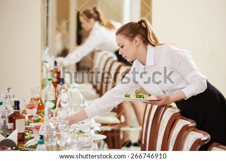 Restaurant catering services. waitress serving banquet table