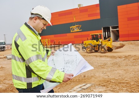 construction engineer builder manager with blueprint drawing project plan at site