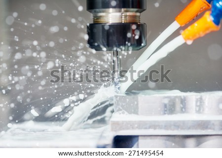 cnc metal working machine with cutter tool during metal detail milling at factory