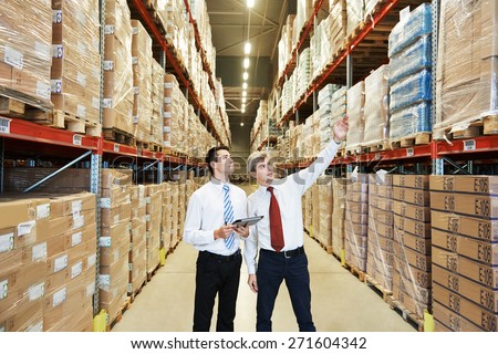 two managers workers in warehouse with bar code scanner