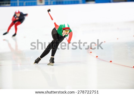 Speed skating young female sportsman during competition race
