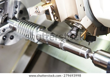 metalworking  industry: mill cutting tool ready to process steel metal shaft on lathe machine in workshop