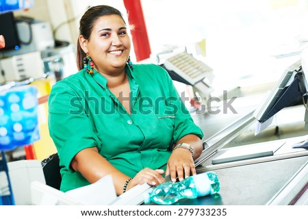 Portrait of seller assistant or cashdesk cashier worker teller in supermarket store