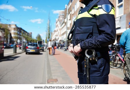 city security and safety. policeman watching order in the urban street
