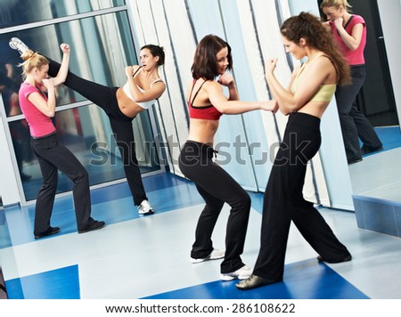 group of woman at fitness gym during martial art fighting physical training excercises thai bo