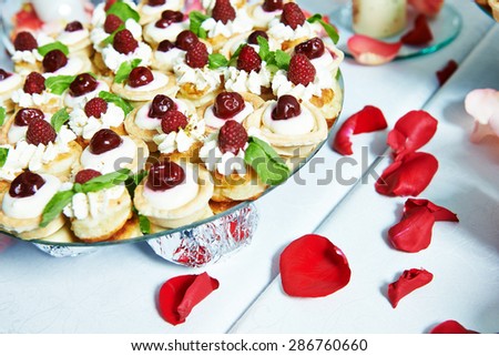 Catering service. Sweets with berries and chocolate at party table