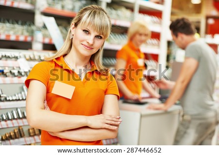 Positive female seller or shop assistant portrait  in hardware supermarket store